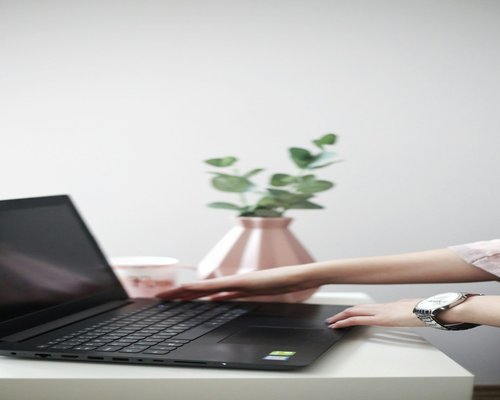Person taking a break from laptop screen at a modern desk